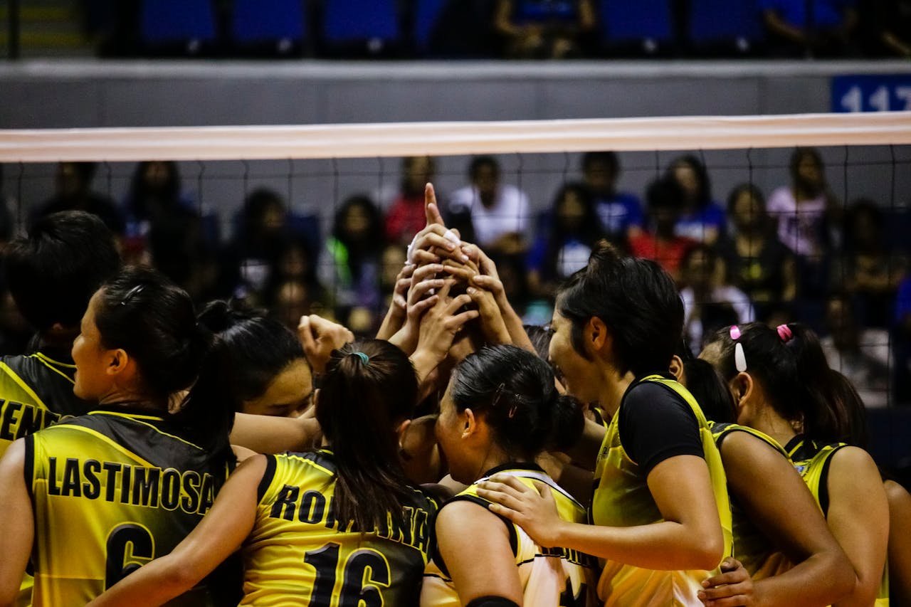 Female volleyball team huddles for a game in Quezon City, Philippines.